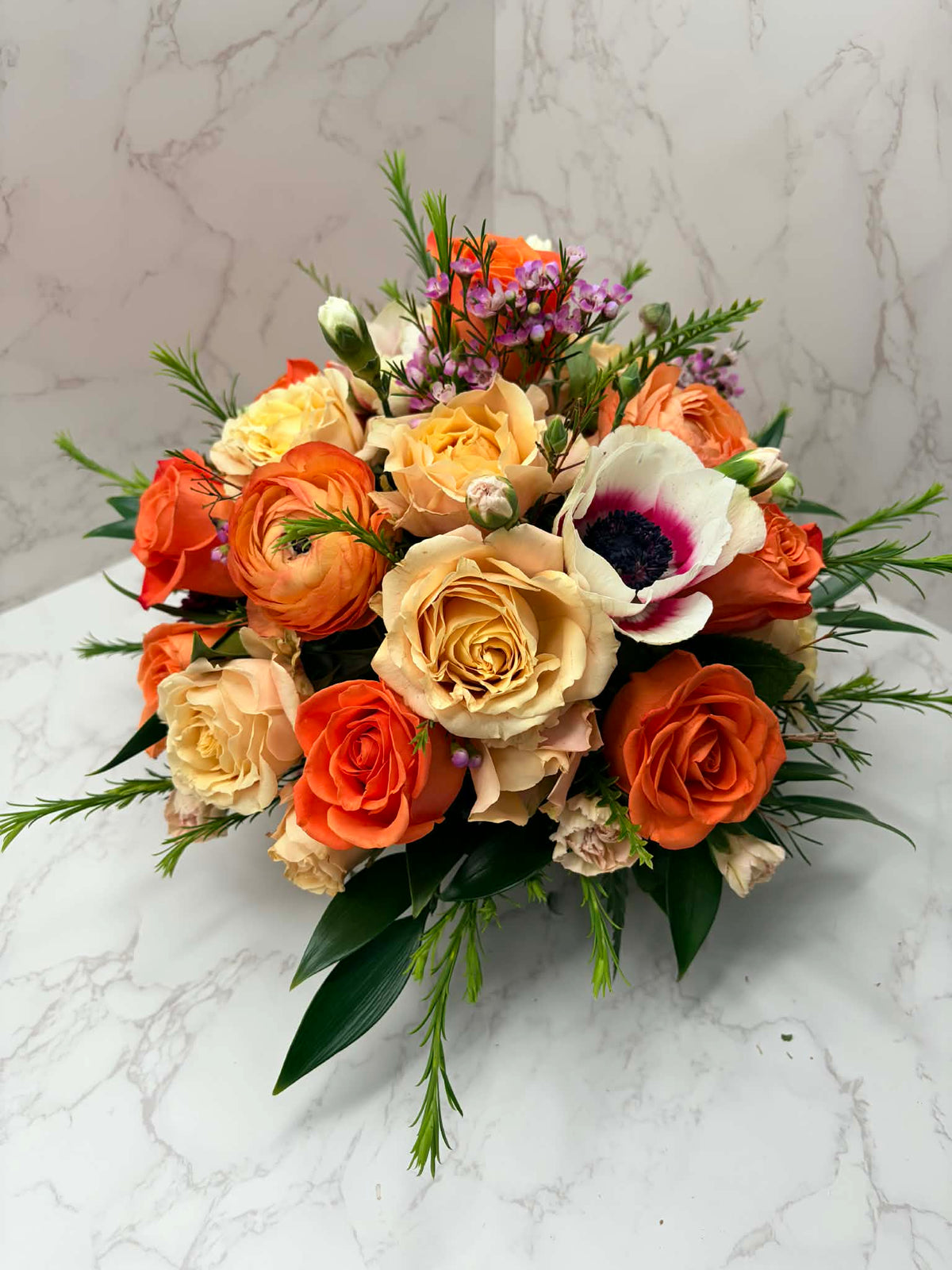 Rose Runners warm orange and peach rose floral arrangement with anemone and delicate filler